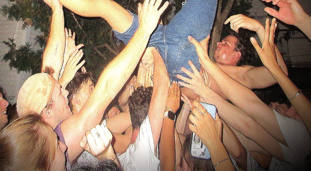 Crowd surfing at a SL4TE house show